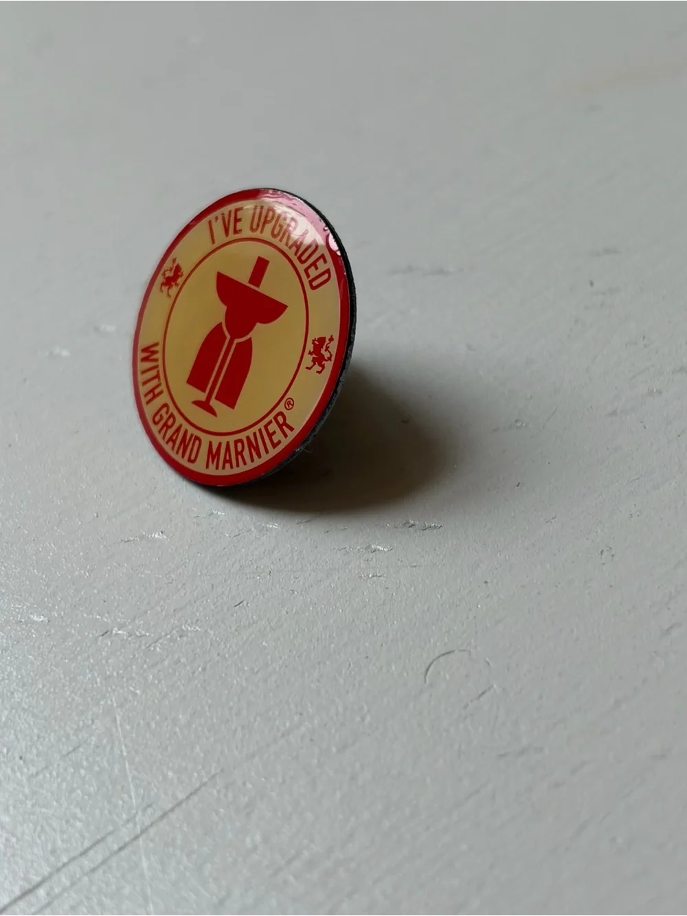 Vintage “I’ve Upgraded with Grand Marnier” Enamel Pinback Tac Hat Lapel Pin